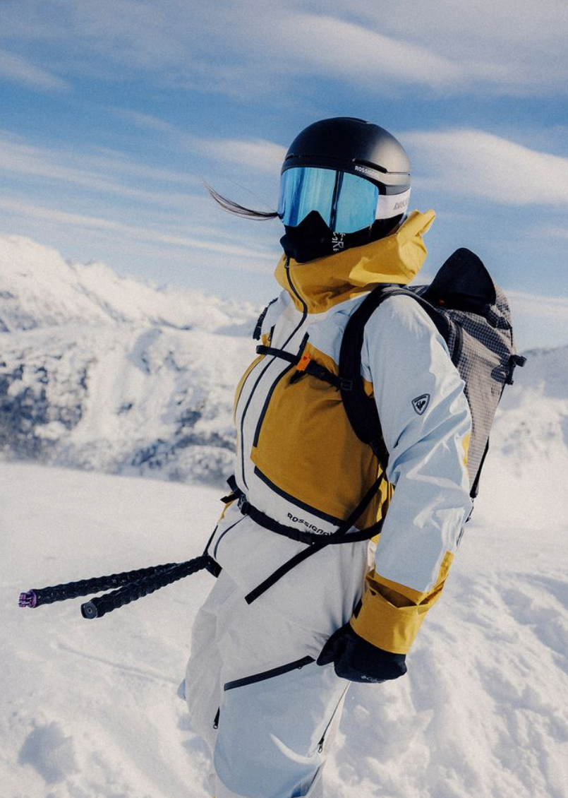 Person in winter gear with skis on a snowy mountain