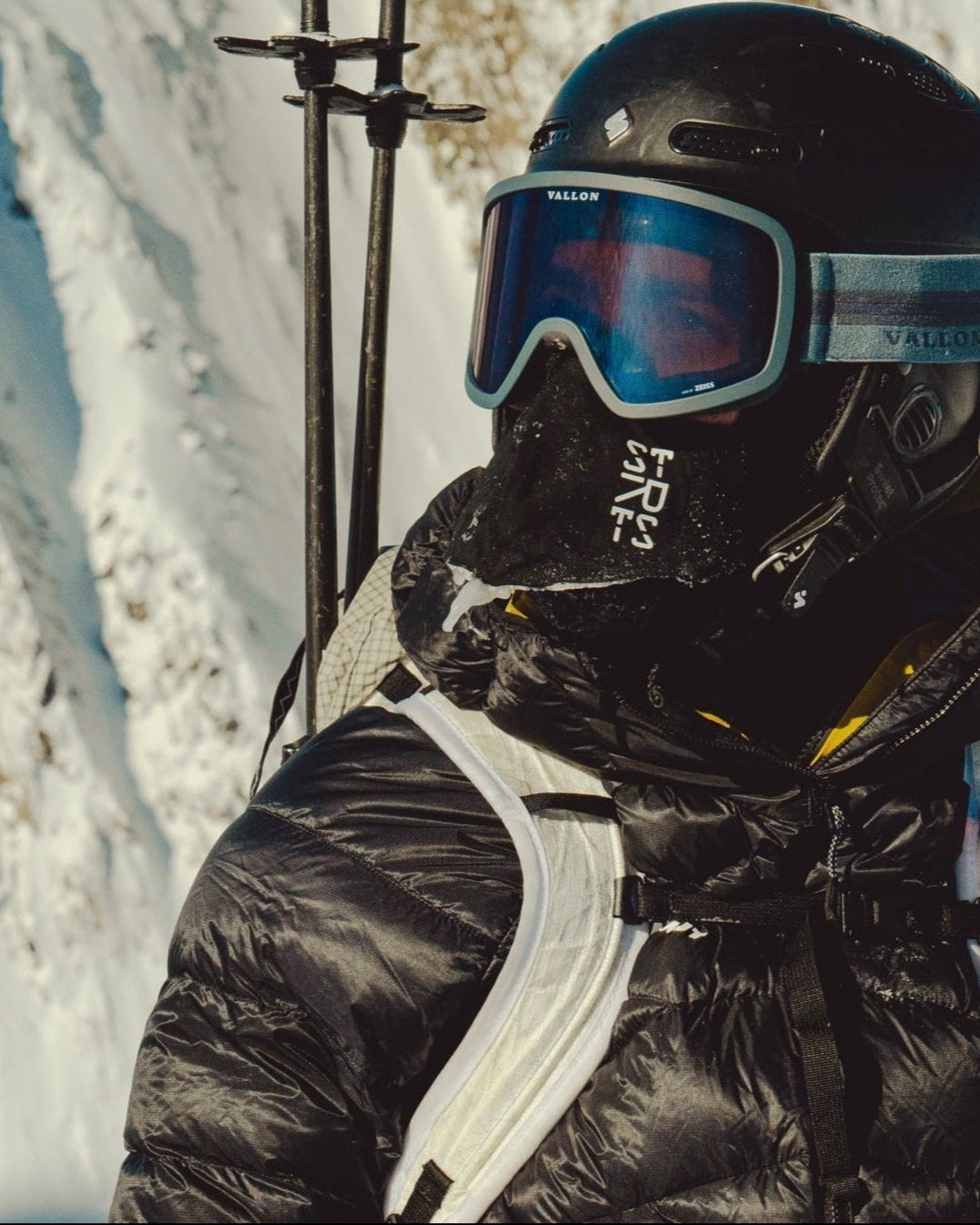 A skier in goggles and a STRATUS balaclava